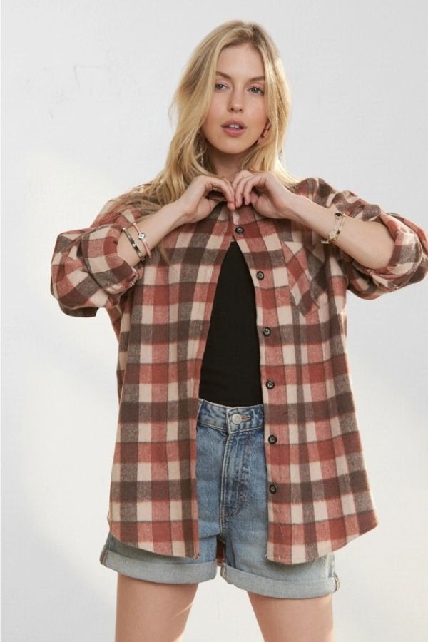 A person wearing a relaxed fit brown and tan Plaid Wool Blend Shacket over a black top and denim shorts.
