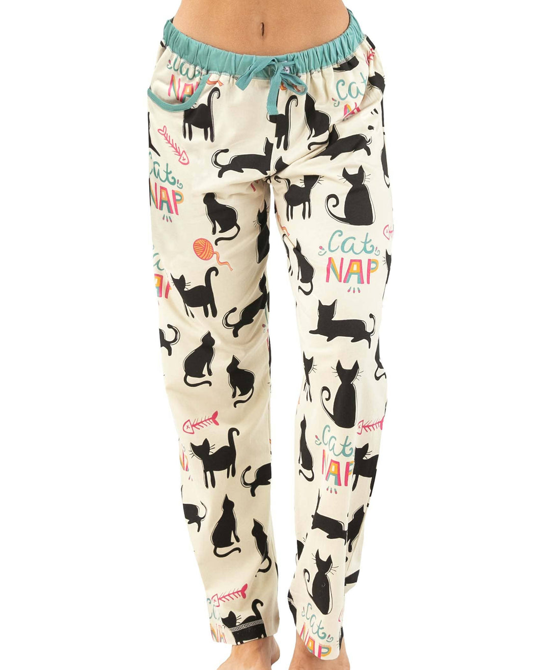 A person wears the Dog Mom, Cat Nap & More Pajama Pants—cream pajama pants with black cat silhouettes, yarn balls, colorful "Cat NAP" text, and a comfy teal drawstring waistband.