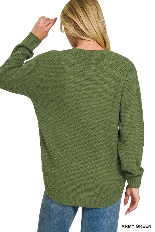 A person with long blonde hair, wearing the Everyday Crew Neck Sweater in army green and blue jeans, is shown from the back. Their left arm is bent, hand resting on the back of their head, showcasing the relaxed fit of this sweater that’s perfect for everyday style.