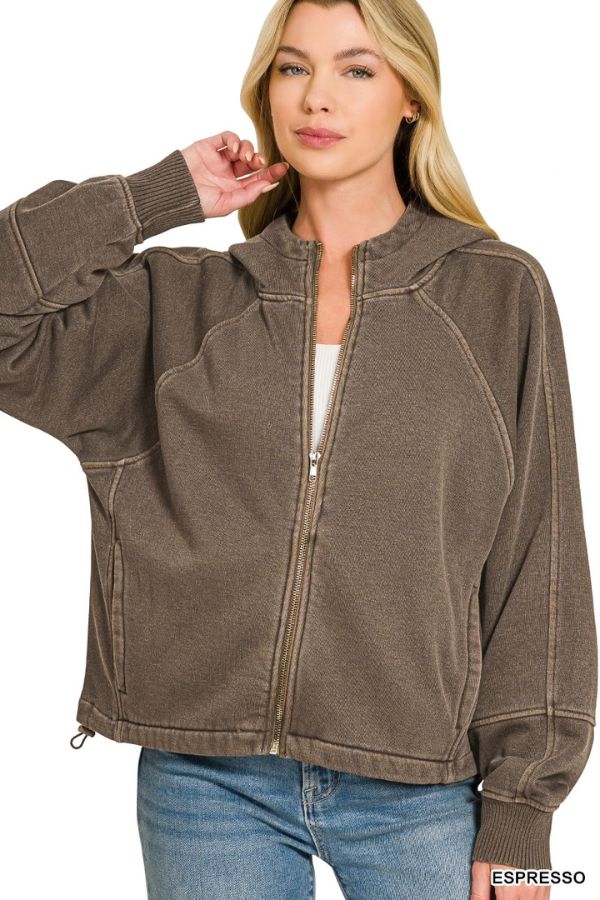 Woman wearing the Pigment Dye Zip Up Hoodie in brown with an adjustable hem, white top, and blue jeans. She has long blonde hair and stands against a white background. “ESPRESSO” appears in the lower right corner.