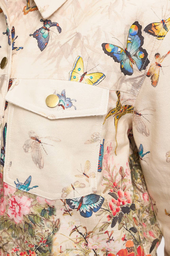 Close-up of the Butterfly Floral Jacket—women's light cotton jacket with a vibrant butterfly, moth, and flower print; features a chest pocket with gold snap buttons.