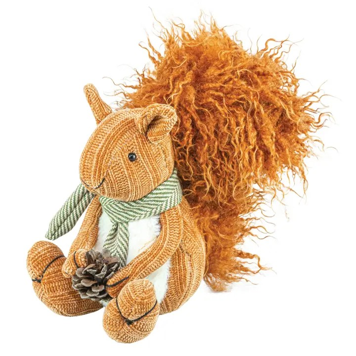 The Plush Fall Squirrel features a striped green scarf and a fluffy tail, and holds a pinecone—making it ideal for fall decor. Crafted from textured orange-brown fabric, this seated plush toy is displayed on a white background.